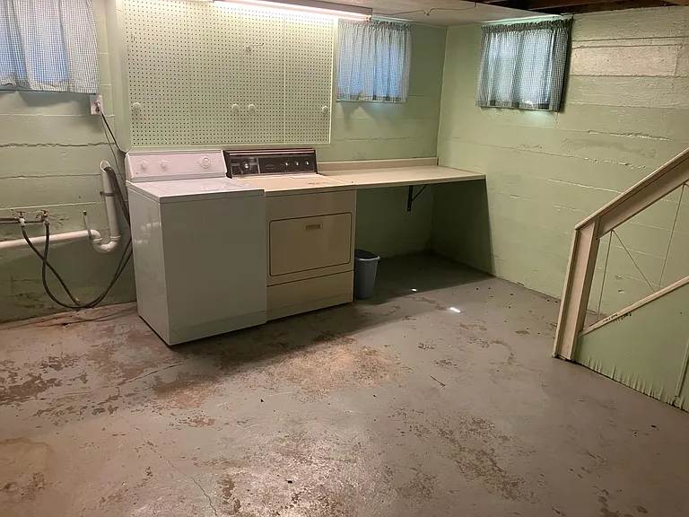 Laundry area of basement. Dryer has been replaced with new unit.