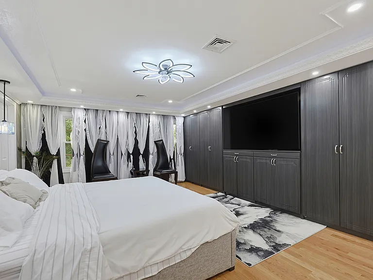 Main Bedroom with Custom built ins and lighting.