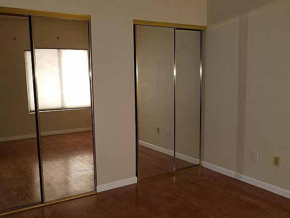 Master bedroom double closet and hardwood floor 