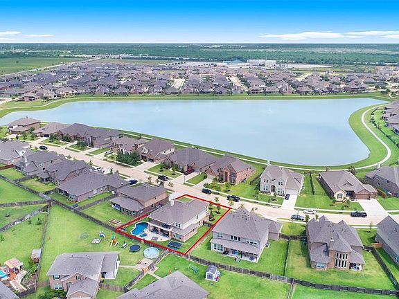 Great aerial view of property and community lake.