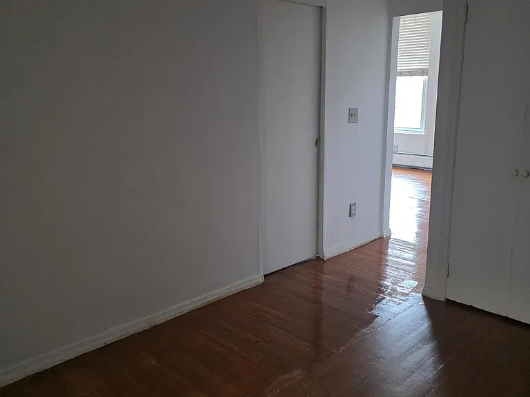 Middle room. Bedroom door can be seen in the picture.