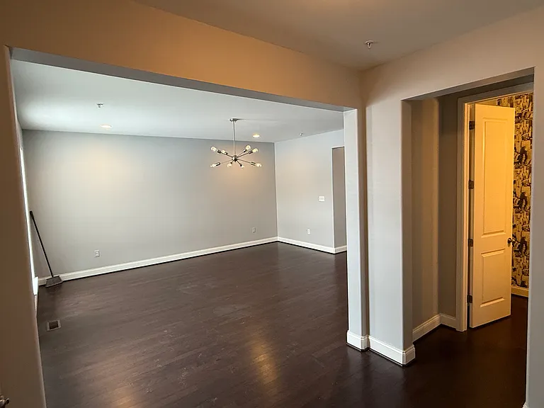 Entryway with livingroom on left and powder room and coat closet on right