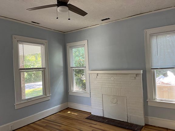 Living room mantle . Large double pane windows flood the room with light