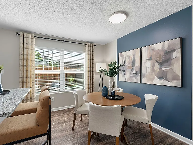 Dining area with hardwood-style flooring & overhead lighting