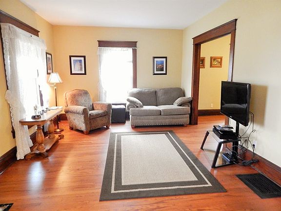 View of the formal living room.  Notice the large windows with beautiful original trim.  Original Oak floors just recently refinished.