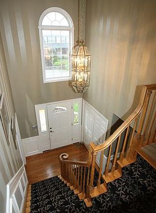 Open Foyer, Custom Staircase & Palladian Window.