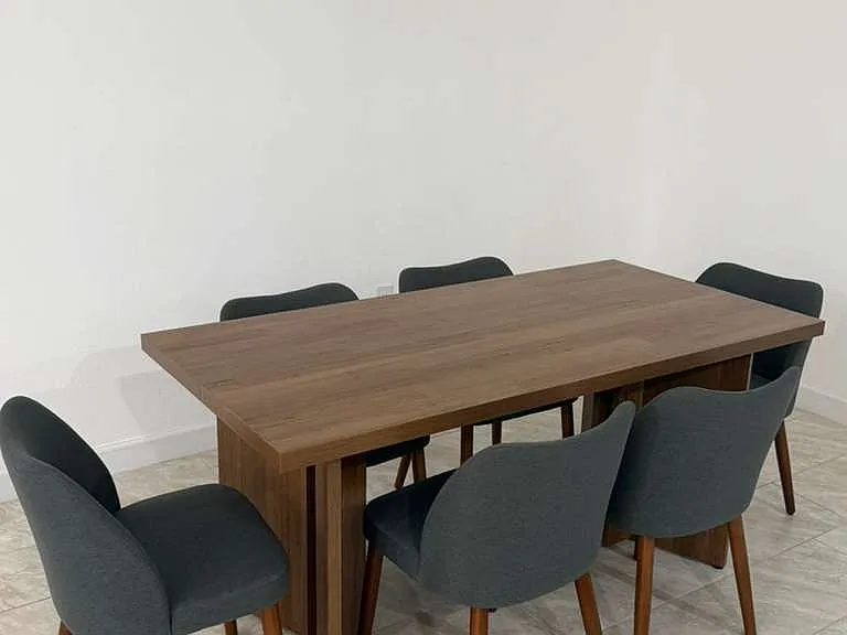 Large wood dining table with two chairs