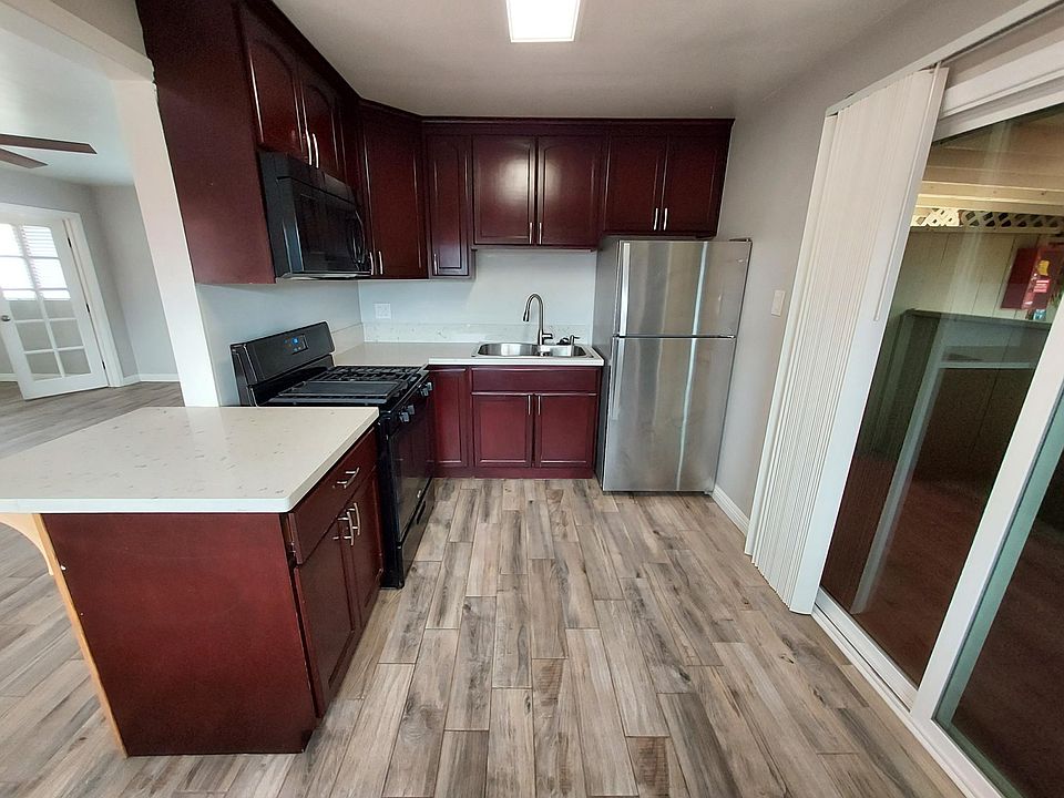 Refrigerator, stove and microwave. Patio access