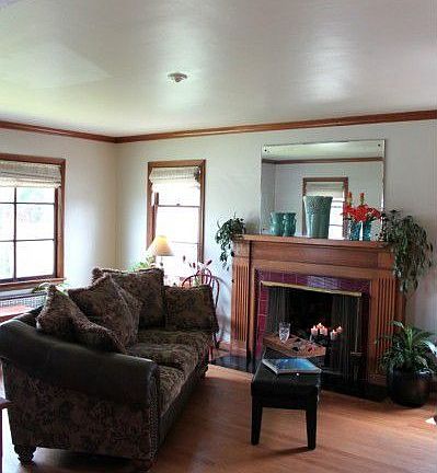 Formal living room with hardwoods, mahogany woodwork and wood burning fireplace.