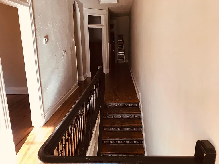View from Landing in hallway towards Kitchen. Entrances to Bedrooms and bathrooms on Left