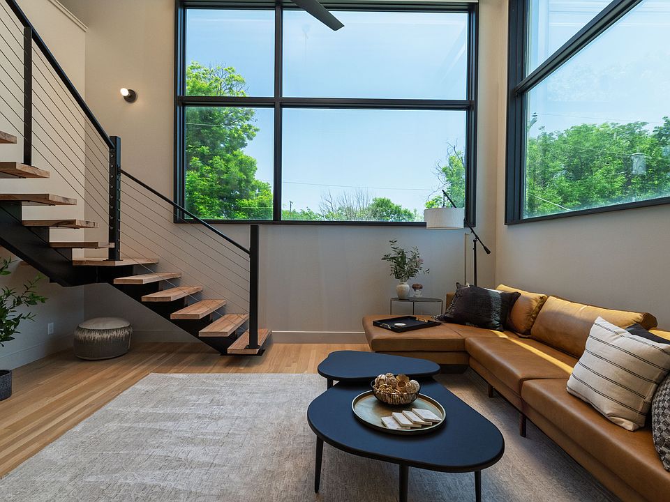 Open concept living room with lots of seating and natural light from the 2 large windows.