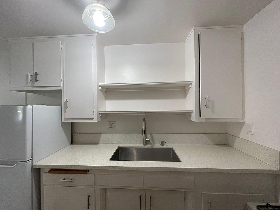 White upgraded kitchen with stainless sink; comes with refrigerator