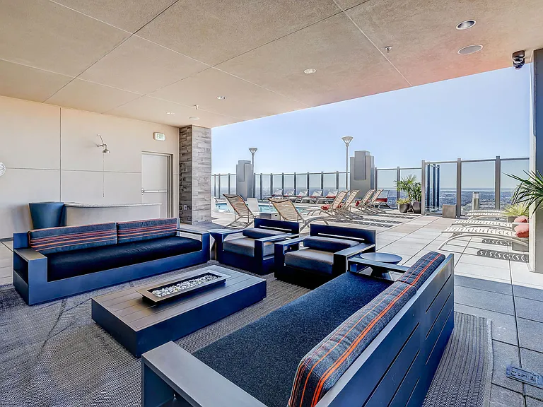 Rooftop lounge seating with fireplace and TV for entertainment