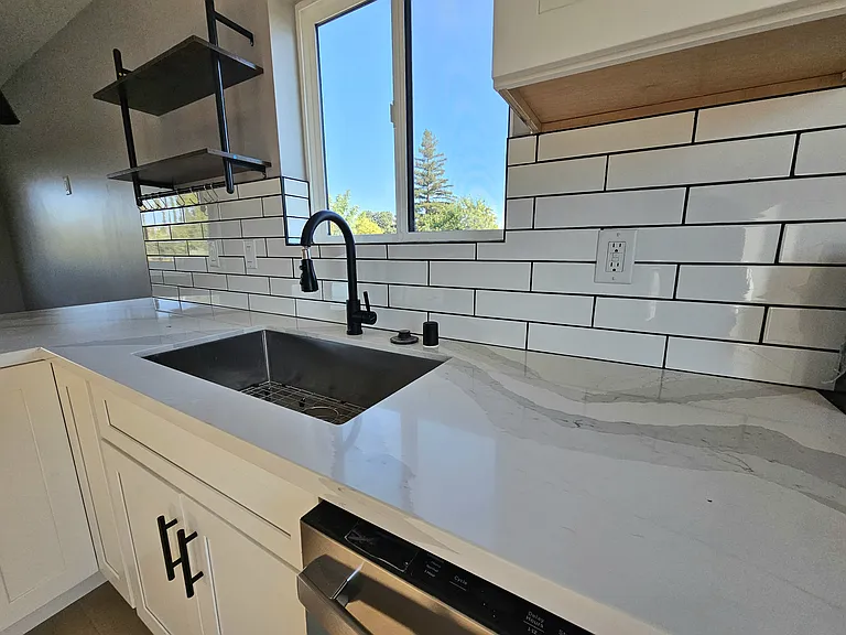 Beautiful undermounth sink with subway tiles.