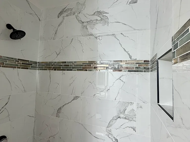 Master bathroom showcasing upgraded tile shower surround and modern finishes