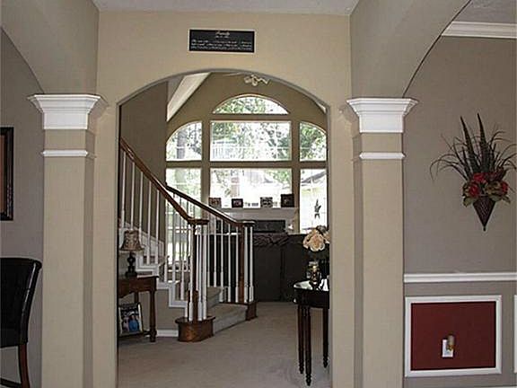 Enter the tiled foyer through the beautiful leaded glass front door
