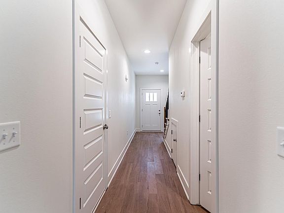 garage door on the left, powder bathroom on the right. Storage under the stairs.