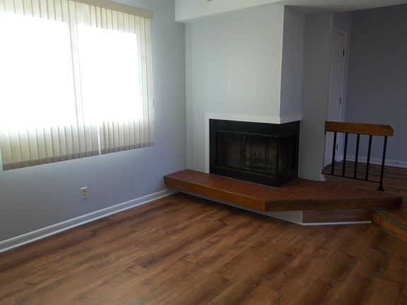 Living room with wood burning fireplace.