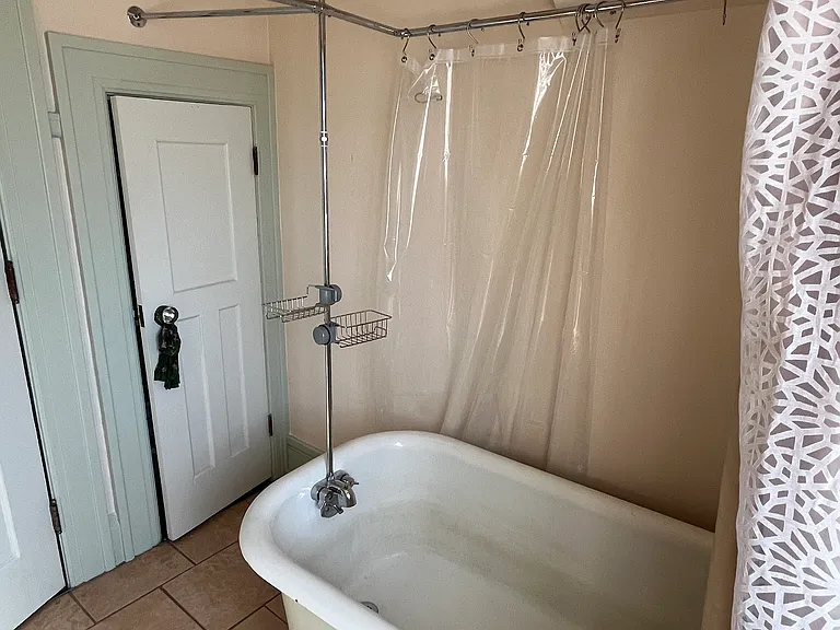 Upper level bath includes clawfoot tub with shower head