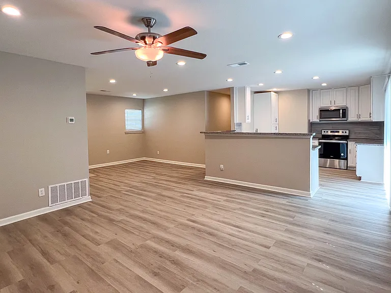 Open-concept living area, recessed lighting, and an easy connection to the updated kitchen and breakfast bar.