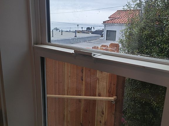 View of ocean from side window in kitchen