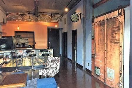 Urban, train station vibe with sliding door to the bedroom.