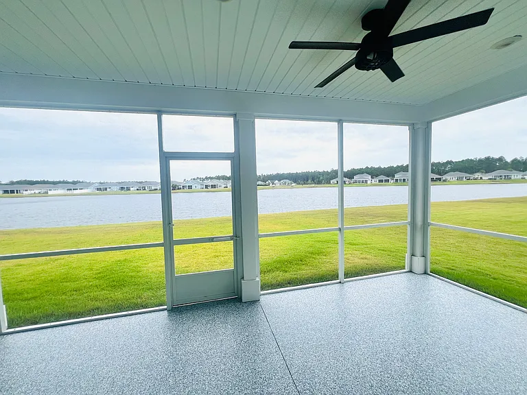 Covered screened-in patio with serene lake views
