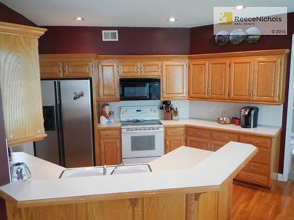 Loads of cabinets in the kitchen. Set up barstools at the raised