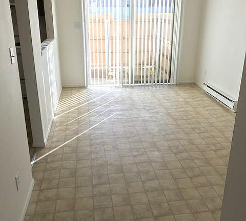 Dining area with sliding door to fenced patio