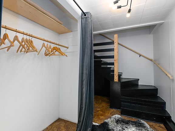 Entry way of apartment with coat closet. Stair lead up to living spaces