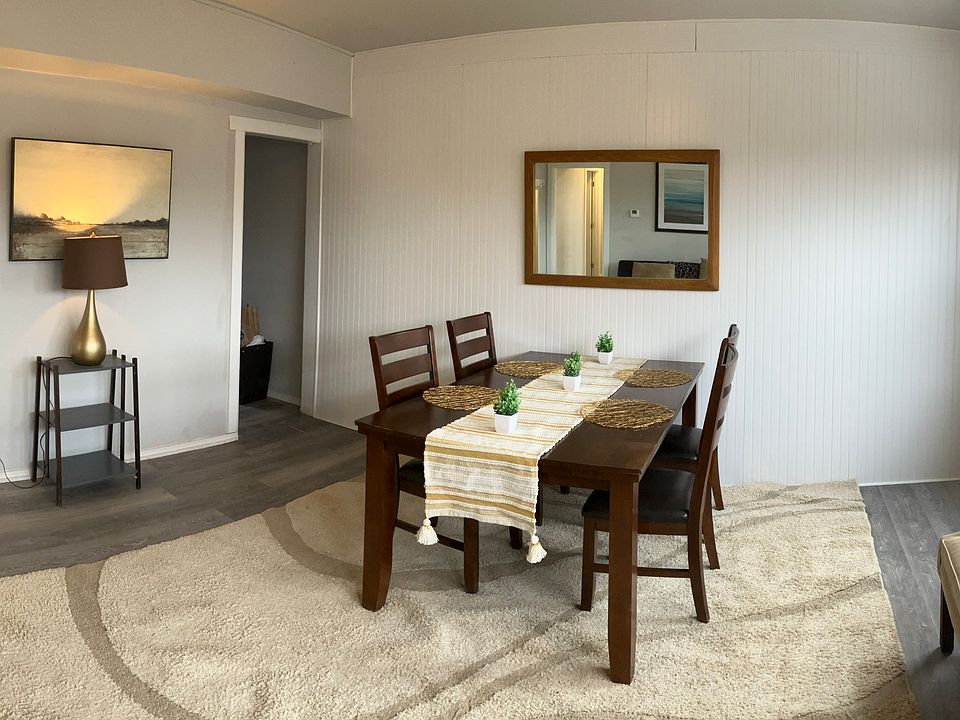 Spacious open living + dining area with large windows and plenty of natural light _ perfect for relaxing or remote work.