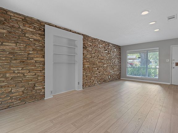 Unit A built in bookcase and stone feature wall