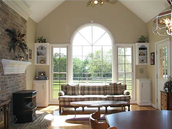 Huge kitchen features a Paladium window, built-in cabinets & hearth.