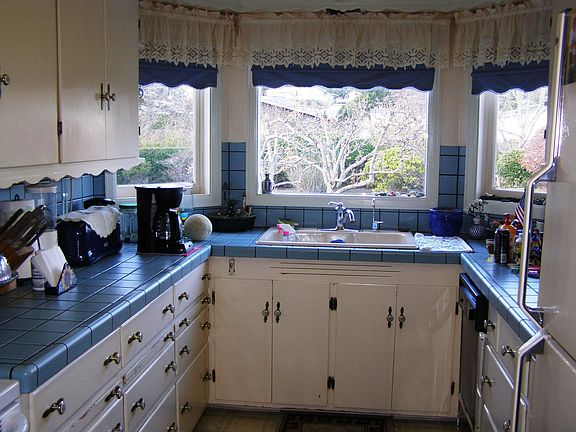 Windows over sink bring in lots of light to kitchen