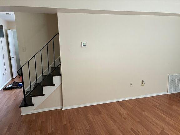 living room view of stairs and dining and kitchen area area