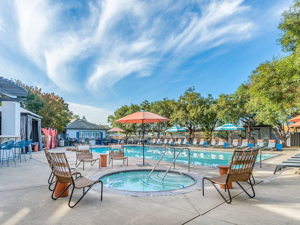 Our resort style jacuzzi and swimming pool is filled with lounge chairs and umbrellas