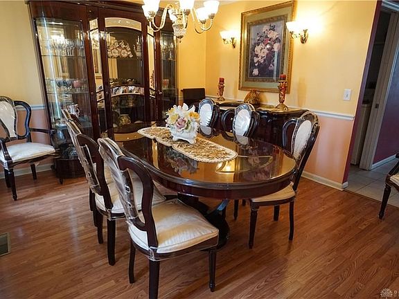 Formal Dining Room with wood floors and chair rail and crown molding detail.