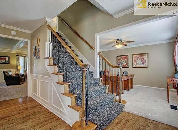 designer carpet on front staircase. Hardwood floors in entry.