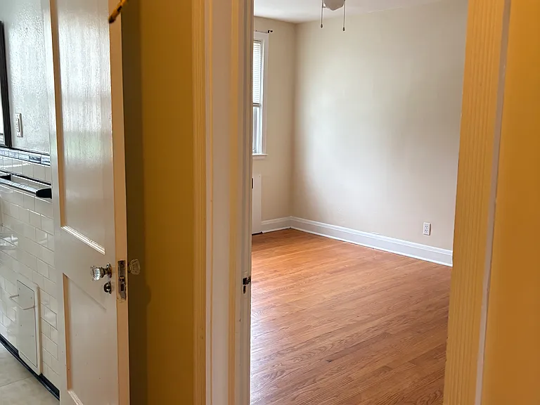 Upper level view into full bathroom and front bedroom