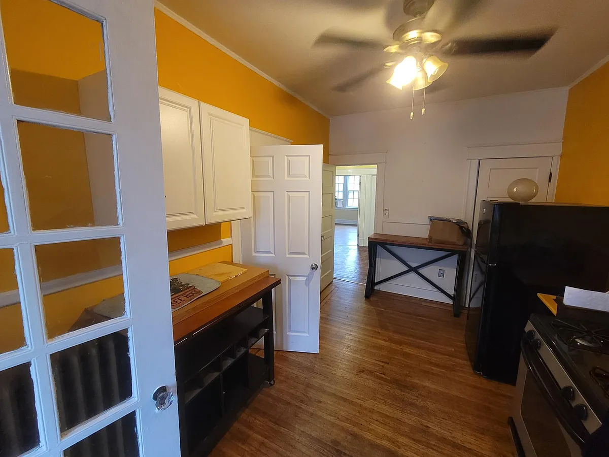 Kitchen with attached enclosed balcony. - 3532 Greenmount Ave #2