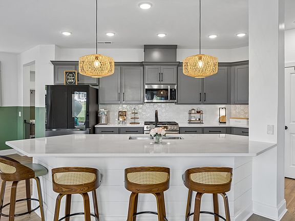 Large kitchen featuring quartz countertops