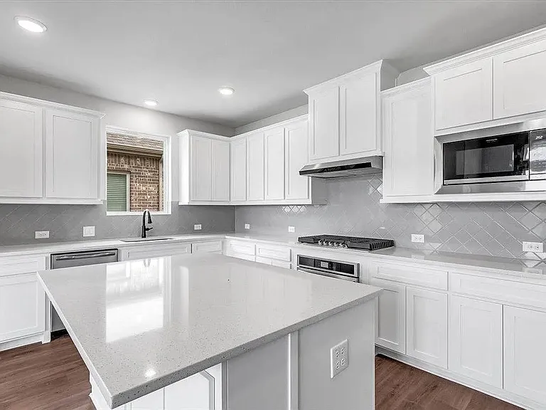 Kitchen featuring a spacious island with a light-toned countertop