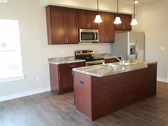 Kitchen with island, Maple cabinets, stainless steel appliances, smooth top stove.
Luxury vinyl plank floors.