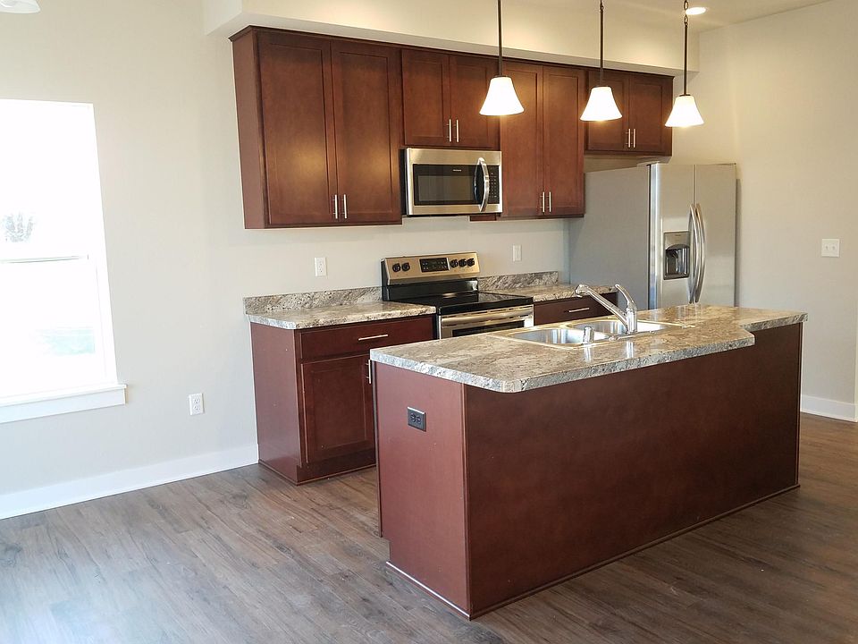 Kitchen with island, Maple cabinets, stainless steel appliances, smooth top stove.
Luxury vinyl plank floors.