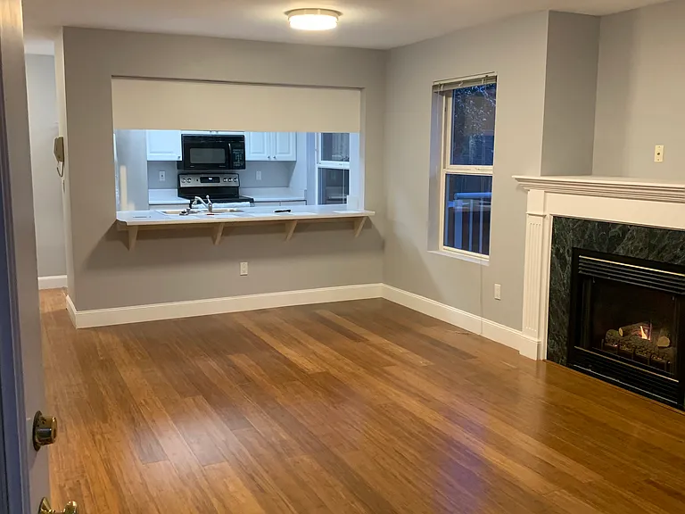 104 Living room with gas fireplace and open to kitchen with breakfast bar