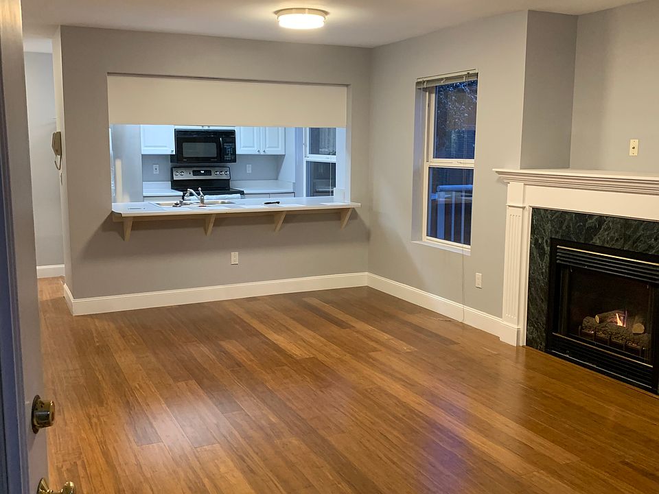 104 Living room with gas fireplace and open to kitchen with breakfast bar
