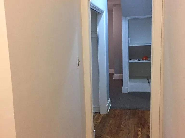 Hallway view of second bedroom which is carpeted.
