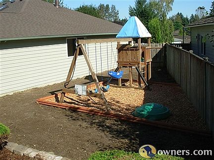 PLAY AREA WITH CLIMBING TOWER AND SWING SET