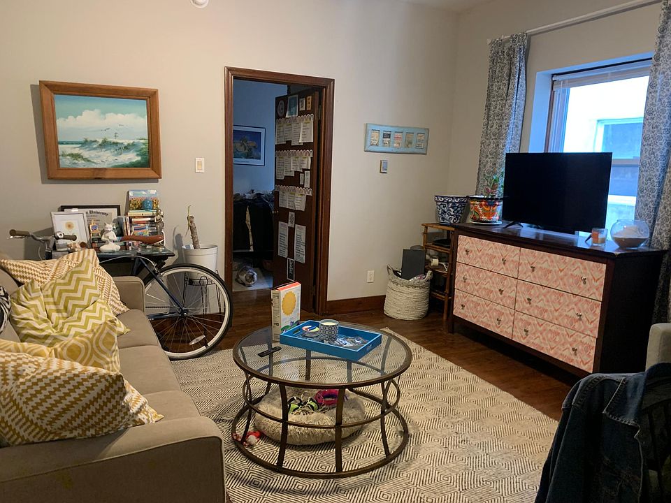 Living room, doorway to bedroom, and deck