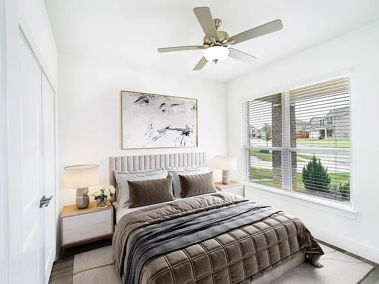 One of four beautifully designed bedrooms at Amavi Celina, this airy space blends natural light with cozy sophistication and neighborhood views.